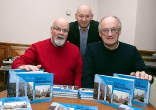 AH MEMORIES. Author of 'Fading Memories', Robert Anderson (right), pictured at the launch of his book on Wednesday night at Coleraine Town Hall along with the Caring Caretaker, Davy Boyle, whose charities will benefit from book sales, and Coleraine Times Editor, Davy Rankin, who provided some of the old pictures from the Times archives.CR48-301SC.