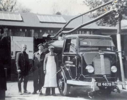 Bobby Jackson (identified by son Albert) in white apron on the right.