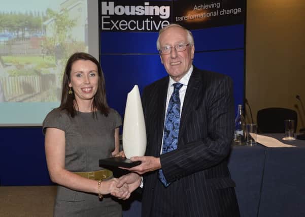 Martina Forrest, one of the founders of the community garden in the Glens estate, picks up the Seamus Roddy Award 2013 at the annual Housing Executive conference.