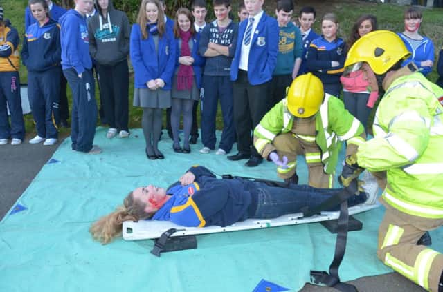 This injured passenger is brought to safety during the collision re-enactment at St Killian's College. INLT 48-314-PR