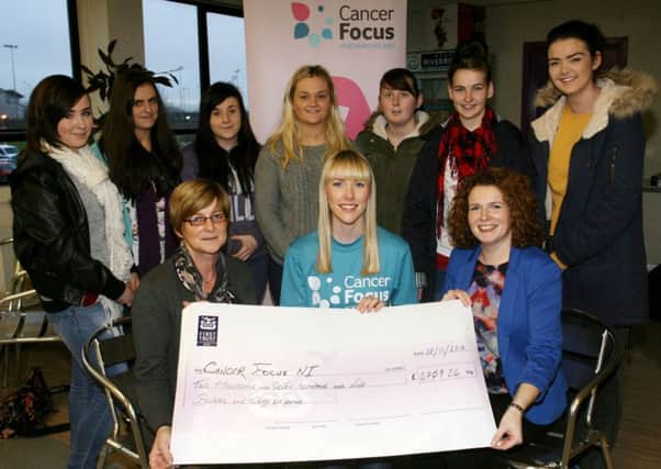 Linda McClintock and Fiona McDowell of the Northern Regional College, present a cheque for £2709-26 to Maeve Colgan of Cancer Focus, money raised from the NRC Wear it Pink Day. Also included are child care students who raised part of the money from a sponsored walk. INBT49-205AC