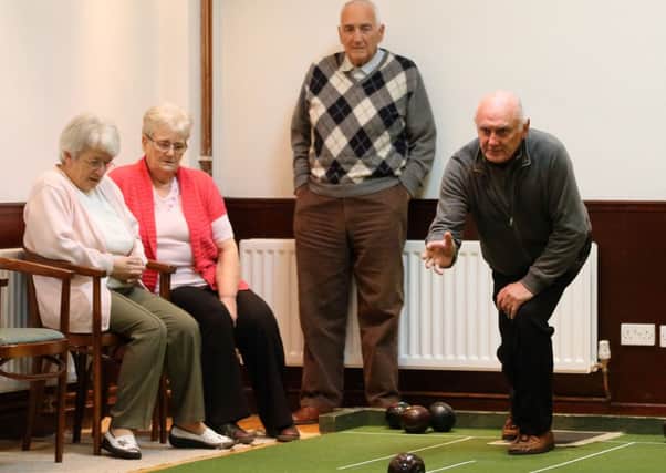 Peter McCann of Portglenone delivers a bowl during last week's league game with the Services Club. INBT 49-176CS