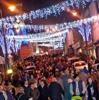 IN THE MAIN. Some of the hundreds of people who turned out for the switch on make their way along Main St on Thursday night.INBM48-13 123SC.