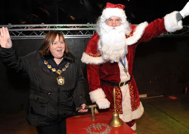 Magherafelt Council chairperson Catherine Elattar joins Santa as they switch on the Christmas lights in Magherafelt.NMM4913-178ar.