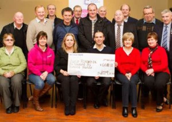 DISTRICT CHEQUE. Members of Garvagh District LOL No4 present a cheque for £6600 to  Mark McMahon of Cancer Research UK in Garvagh British Legion on Thursday evening.CR49-119SC.