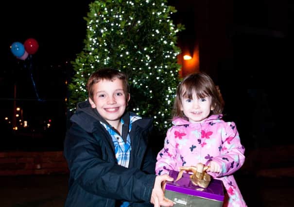 Cole Delbert and Lily Stitt from Castlereagh help to switch on the Christmas lights at Greens Pizzeria in Ballyhackamore.