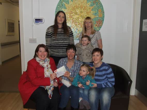 The family of the late Richard Gibson, from Knockview Road, Newtownabbey, (back from left) Lauren Molloy, Lola Molloy, Lisa Gibson (Richards wife) and front: Ann Gibson, Roxi Gibson Meharg and Carrie-Ann Gibson present a cheque to Sharon Gorman, donor officer, NI Hospice. INNT 49-456-CON
