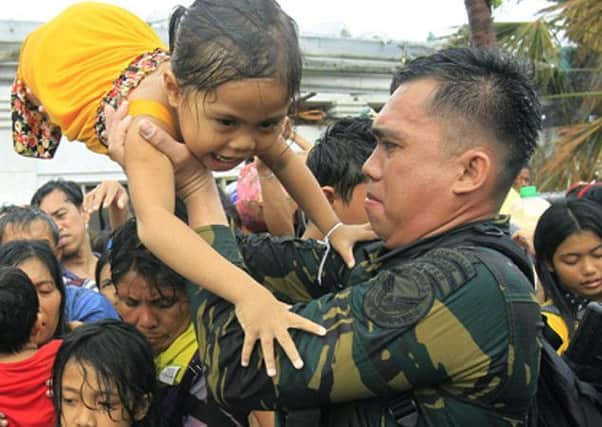 Philippine military personnel try to prioritize children and women first as people wait for evacuation flights in Tacloban, Central Philippinesnon Tuesday last. 1411 INDD 1 Phillippines MVB