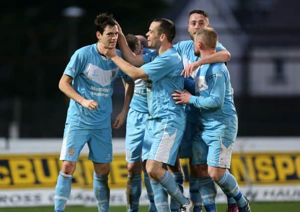 Mark Surgenor is congratulated by his team mates after scoring his team's opening goal in his team's 2-0 win over Ballinamallard
. Picture: Press Eye.