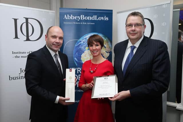 Jill Robb of Ambition Digital is presented with her award by Paul Terrington, chairman of the Institute of Directors Northern Ireland and Maurice Boyd, managing director of the awards' sponsor Abbey Bond Lovis (photo by Kelvin Boyes / Press Eye) INCT 49-707-CON