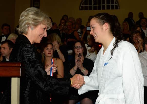 Eorann O'Neill from Larne Swimming Club receives her runners-up medal from HRH The Duchess of Gloucester.