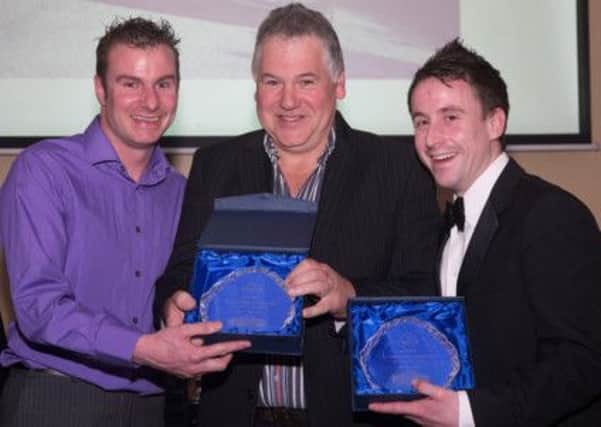 Michael Nutt (right) and his co-driver, Jimmy McKeefrey (left) receiving their trophy last year from a NI rally official.
