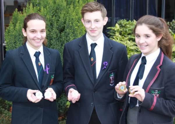 Ruth Russell, Kyle Mawhinney and Rachel Bethel from Wallace High School who all won medals at the recent Ulster Grammar Schools Swimming Championships.