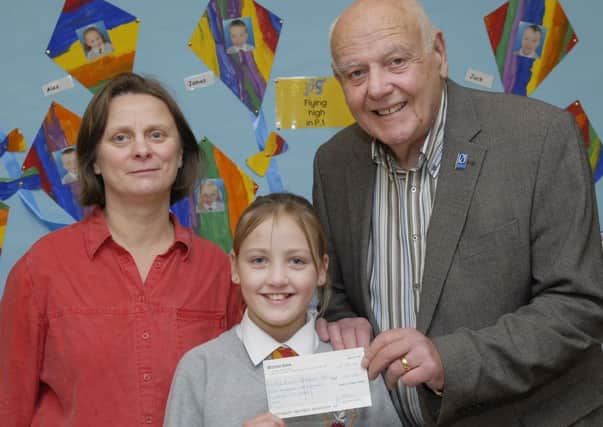 Fountain Primary School pupil Leona Orr pictured handing over a cheque for £170.00, raised during their Christmas Service in Carlisle Road Methodist Church, to Jack Glenn, Chairperson of the Foyle Branch of Parkinson's UK. Included is Cathy Arthur, Principal. INLS5212-111KM