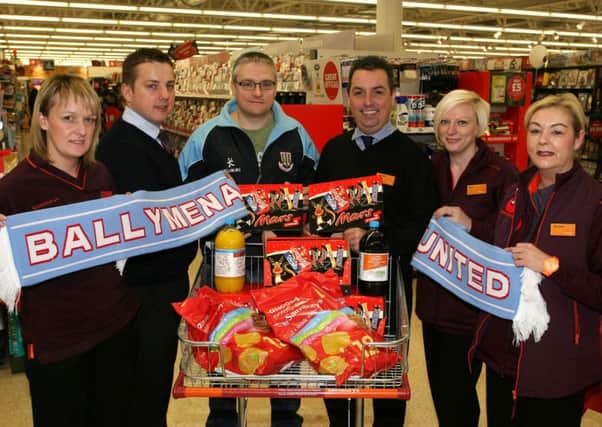 Ashley Shaw of Ballymena United Junior Sky Blues, is pictured with Sainsburys staff Shelly Blair, Paul Carr, Daniel Pritchard, Kim Russell and Michelle Gregg, who donated goods to the Sky Blues for their Christmas party. INBT48-202AC