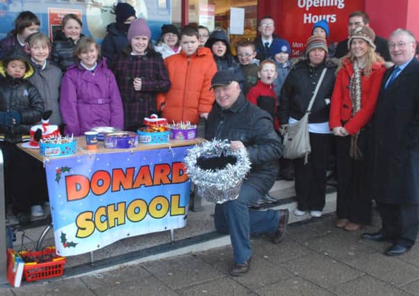 Pupils from Donard School joined local MP David Simpson when he held his annual fundraising sit out in Banbridge Town Centre. INBL50-SIT2