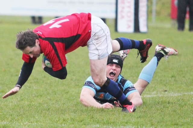 The Coleraine player evades a last gasp tackle.