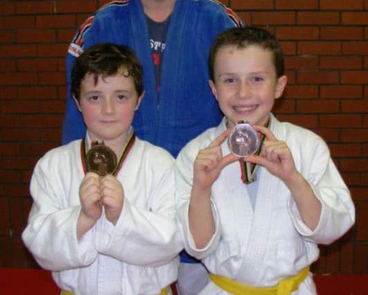 Bronze medallists Joel Duncan (left) and Jack Mathews with Coach Philip Duncan.