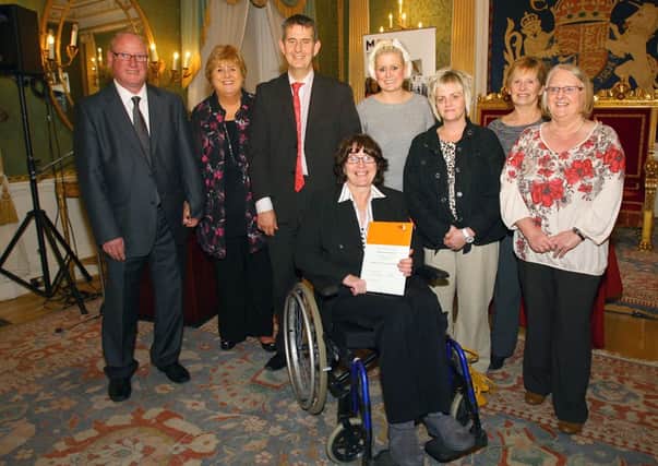 MS Society Larne Branch volunteers (from left) Colin Richardson, Margaret Fry, Aimee Dix, Tanya McKillop, Linda Erskine, Jenny Bindley and Caroline Millar with Health Minister Edwin Poots at the Hillsborough reception. INLT 50-627-CON