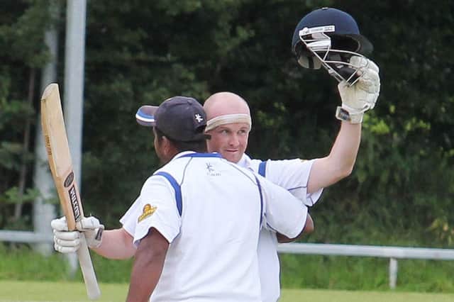 Coleraine's batsman Niall Mc Donnell, celebrates a century with team mate Roy Silva, against Brigade on Sunday at Rugby Avenue.PICTURE MARK JAMIESON.