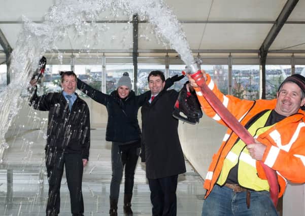 ILEX interim Chief Executive Mel Higginsand , right and Noel McMonagle from the Foyle Hospice  get his their skates ready at the Legenderry on Ice Marquee at Ebrington Square as the first water is poured into the ice rink ahead of the opening on thursday afternoon. Included are Tim O'Donoghue,  and Silviya Marinova from Legenderry On Ice. PIcture Martin McKeown. Inpresspics.com. 09.12.13