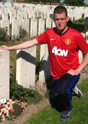 Philip Jackson pictured in one of the many graves visited by the Cathedral Youth Club visit to The Somme. The Cathedral Youth Club will reflect on the trip on Thursday (December 12).