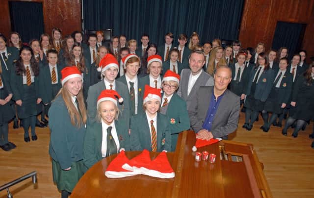 Pupils from the Friends School choir who will be appearing in Peter Corry's The Music Box at The Waterfront Hall get in some preparation helped by Peter Corry, show producer, and Ashley Fulton, vocal director. INUS4913-FRIENDS2