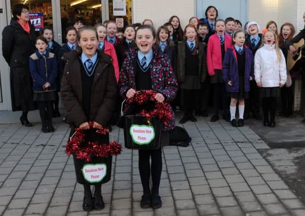 Cara Jeffrey and Olivia Kennedy pictured taking collections for St Vincent de Paul and the Simon Community as pupils from St Josephs Primary School sing a selection of festive songs and carols in Bow Street on Monday 9th December.