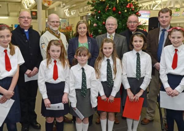 Children from Broadbridge and Eglinton Primary School Choirs who took part in the annual cross community Christmas Carol Service at City of Derry Airport. Included are Rev. Brian Hasson, Steve Hincliff, Charlene Shongo, City of Derry Airport, Sammy Cochrane, Father Noel McDermott and Rev. Lindsay Blair.The concert raised money for the charity SOS Children. Picture Martin McKeown. Inpresspics.com. 08.12.13