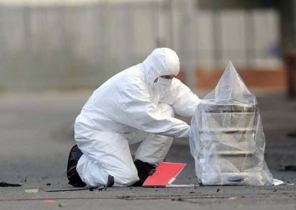 Police forensic officer at the scene of a security alert.