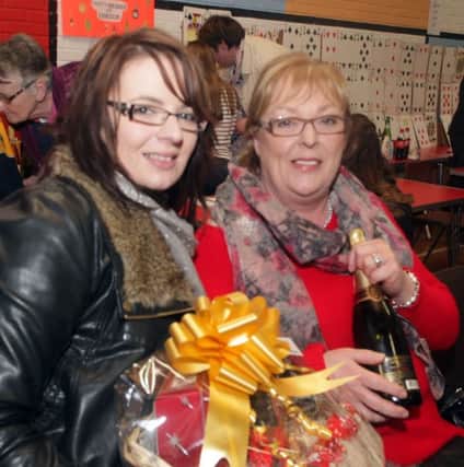 HAMPER AND SHAMPERS. Pictured with a hamper and champagne won at St Brigid's PS Christmas Bazaar on Sunday are Pat and Ciara McGuigan.INBM51-13 016SC.