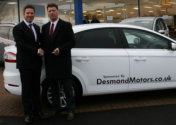 Gareth Mallon presenting the keys of a Ford Mondeo, sponsored by Desmond Motors main Ford dealers, to Derry City FC manager Roddy Collins.