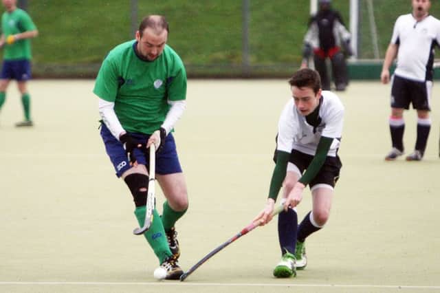 Ballymena 2nds player Phil Moody is dispossessed by his Down opponent. INBT51-263AC