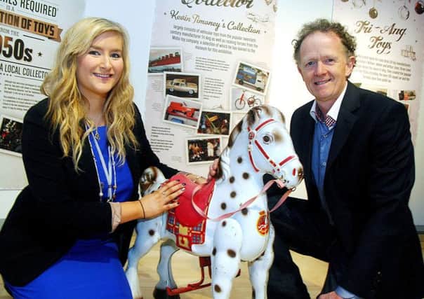 Rebecca Gordon, Mid Antrim Museum Assistant, joins Kevin Timoney in the Braid Arts Centre to launch his collection of "Tri-Ang and Mobo Toys" on display in the Braid Arts Centre's Christmas "No Batteries Required" exhibition. INBT 51-811H