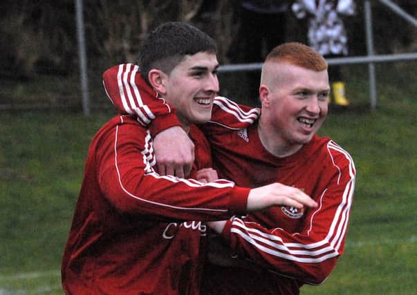 Gary Workman is congratulated by team-mate Stephen Smyth after scoring for Islandmagee in the match with Dunmurry Rec. INLT 51-369-PR