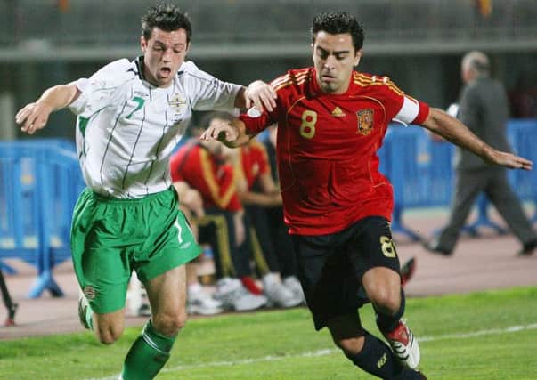 Spain and Barcelona great Xavi tussles with Northern Ireland winger Ivan Sproule during their Euro 2008 Qualifier in Gran Canaria.