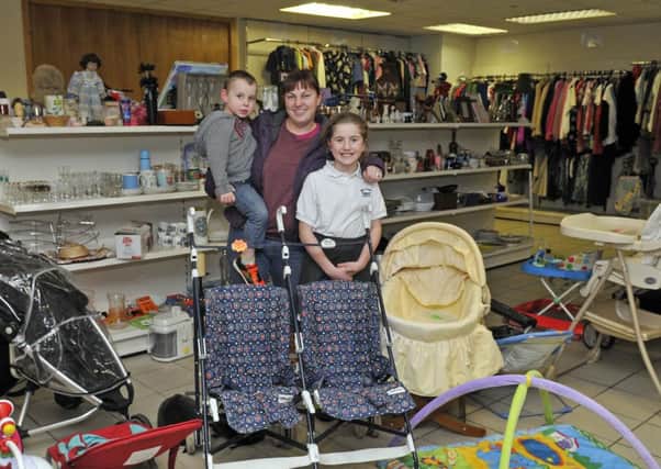 Holly Cregan and children Nathan and Robyn in their charity shop at Mid Way Autopoint. INLM51-104gc