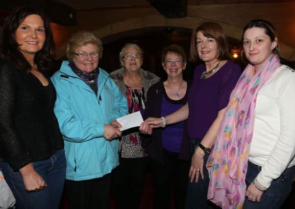 Chairman of Ballymena Floral Art May Knox (2nd left) presents a cheque for £500 to Martina McGarry of Ballymena Autism N.I. Support Group while looking on are group members Mary Magowan, Denise Fyfe (chairperson) and Laura McClelland and Ballymena Floral Art secretary Audrey Steed (centre). INBT 51-113JC