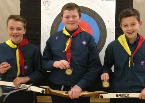 The winning team from 1st Islandmagee Scout Troop, Andrew Gibson, Ian Dick and David Bell, archery champions of South East Antrim. INLT 52-652-CON