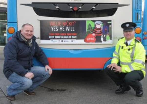 Chairman of the Lisburn PCSP, Councillor Stephen Magennis and Area Commander, Chief Inspector Darrin Jones launch the 'Willie Nickit' back of bus advertising as part of the overall Christmas Crime Prevention Campaign.