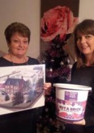 Roisin Scott and her mother Maureen Ferris show off the new plans for Somerton Hospice after raising over £1,600 for the new build