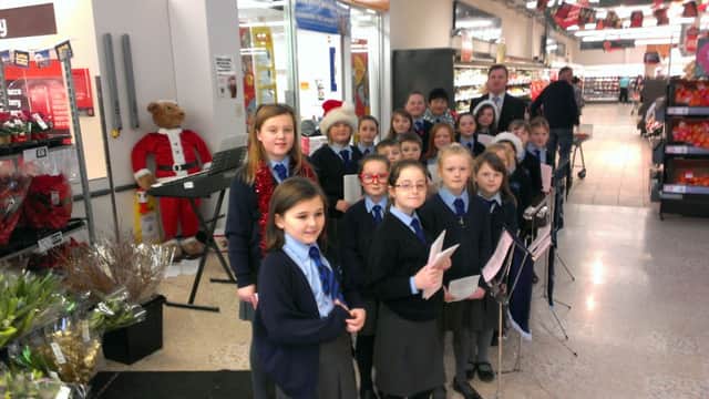 Carrickfergus Central Primary School singers performing at Sainsbury's, included is principal Glen Campbell. INCT 52-701-CON