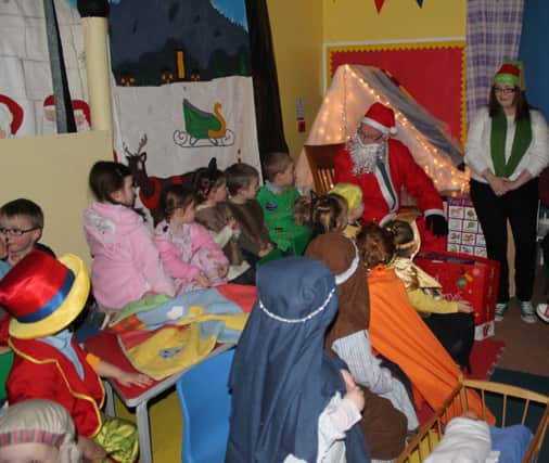 Santa visits the well behaved children at Naíscoil an Chaistil. INBM52-13