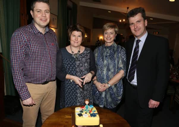 Cathy Humphrey who is leaving Buick Memorial Primary School, Cullybackey after eighteen years service to take up the post of principal of Groggan Primary School is seen here with Buick Primary School principal Mr Russell White (right), senior teacher Mrs Audrey Philson and Cathy's husband Denver Humphrey as she prepares to cut her special cake at a dinner in her honour in Galgorm Castle Golf Club. INBT 52-122JC