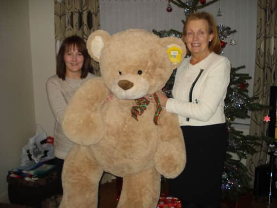 Karen Johnston (left) receiving the teddy she won at the Inner Wheel Club of Carrickfergus 'Guess the Teddy' competition at Sainsbury's Carrickfergus.  Also pictured is Jeanette Sproule, Club President.  Proceeds went to the NI Children's Hospice.  INCT 01-720-CON