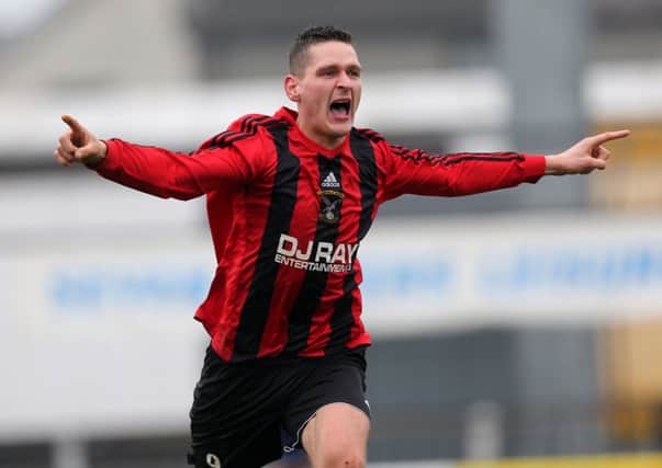 Harryville Homers Alan Rainey celebrates after scoring his team's fifth and winning goal in extra time of Homers 5-4 win over Randalstown Sky Blues in the County Antrim Post O'Kane Cup final at Ballymena Showgrounds. Pic by John McIlwaine