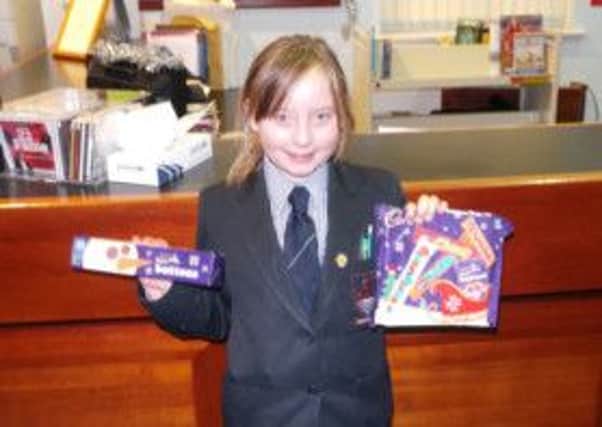 Year 8 pupil Amy Abraham collects her prizes for being a top detective in Larne Grammar School's 'Murder in the Library' event.  INLT 01-681-CON