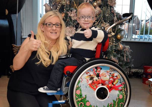 Blake McCaughey (6) and his mum Christine with his new wheelchair which arrived at Christmas. INPT01-207.