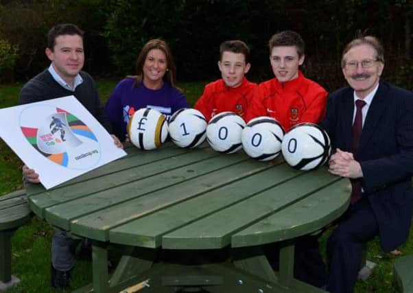 Northern Ireland Cup Chairman Victor Leonard (right) along with County Antrim Chairman Lawrence Anderson (left) and County players Kyle McClean and Josh Curry, hand over a cheque to Noreen Kennedy, Northern Ireland Childrens Hospice.