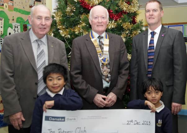Pictured with Whitehead Primary School pupils Bret and Eisle presenting the cheque for ShelterBoxes for the Philippines are, from left, Carrickfergus Rotary Club president-elect Sam Crowe, president Billy Luney and school principal Jim Loughins. INCT 02-702-CON ROTARY